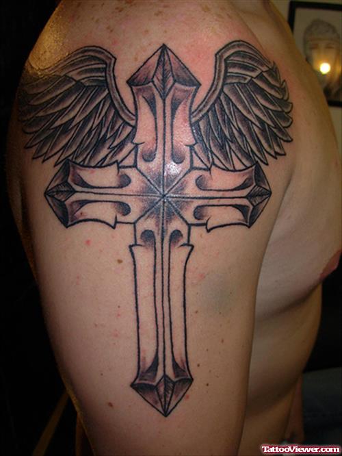 Grey Winged Cross Tattoo On Man Right Shoulder