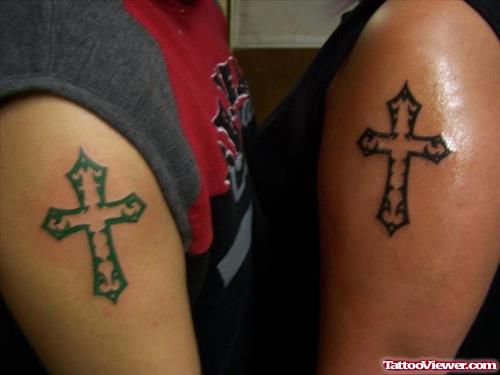 Green And Black Cross Tattoo On Half Sleeve