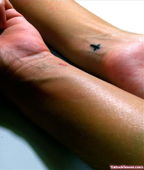 Attractive Black Ink Cross Tattoo On Left Wrist