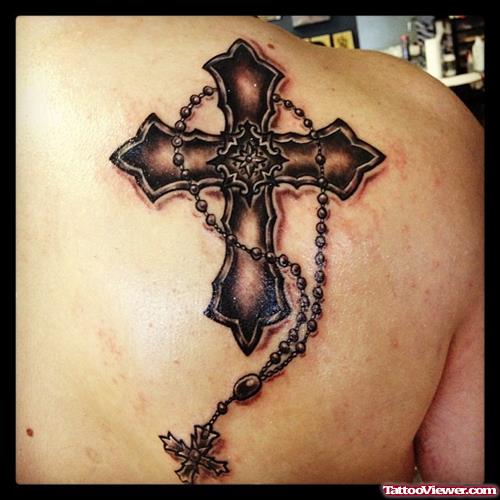Dark Ink Cross And Rosary Tattoo On Right Back Shoulder