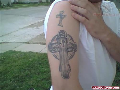 Grey Ink Cross With Eyes Tattoo On Bicep