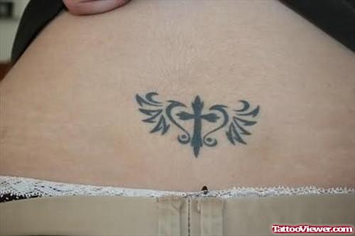 Small Size Cross Tattoo On Lower Waist