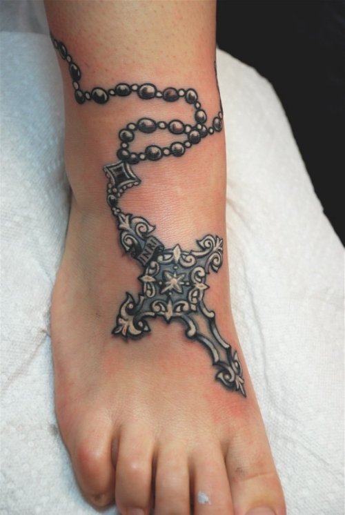 Grey Ink Rosary Cross Tattoo On Right Foot