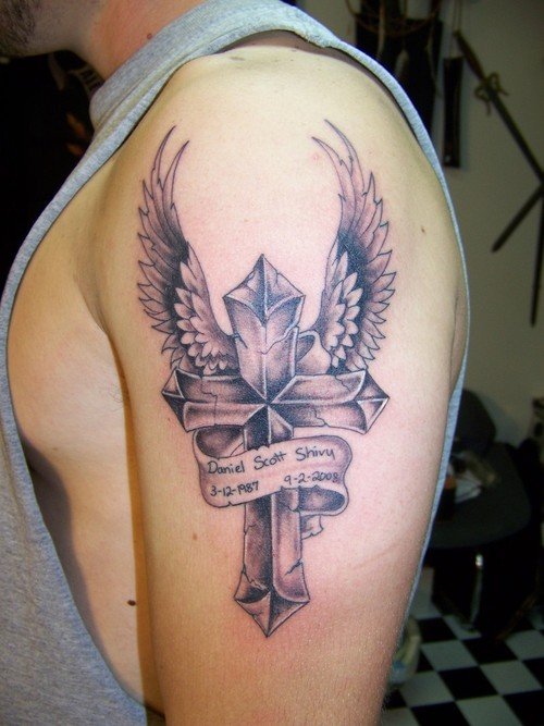 Grey Ink Winged Cross Tattoo On Left Shoulder