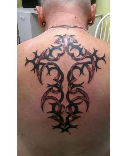 Red And Black Ink Cross Tribal Tattoo On Man Upper Back
