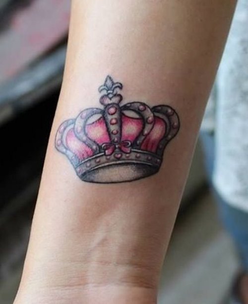 Grey And Pink Crown Tattoo On Forearm