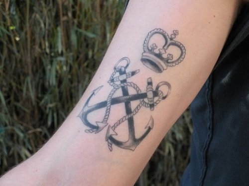 Grey Ink Anchors And Crown Tattoo On Arm