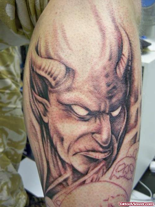 Grey Ink Devil Head Tattoo On Leg