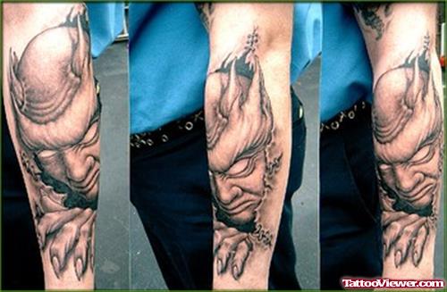 Riiped Skin Demon Head Tattoo On Sleeve