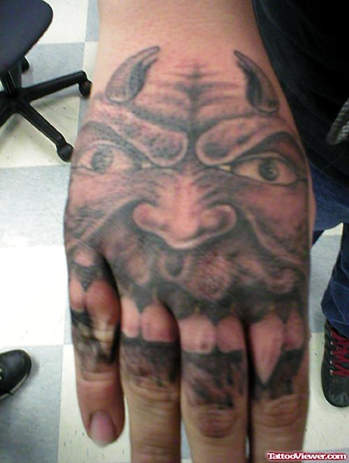 Grey Ink Devil Tattoo On Right Hand