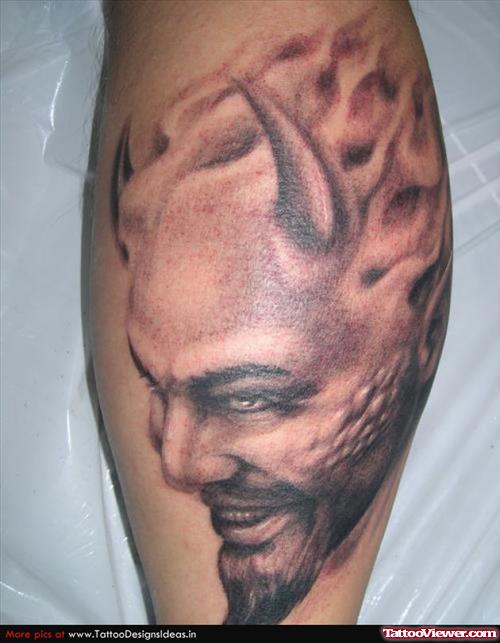 Grey Ink Devil Head Tattoo On Back Leg