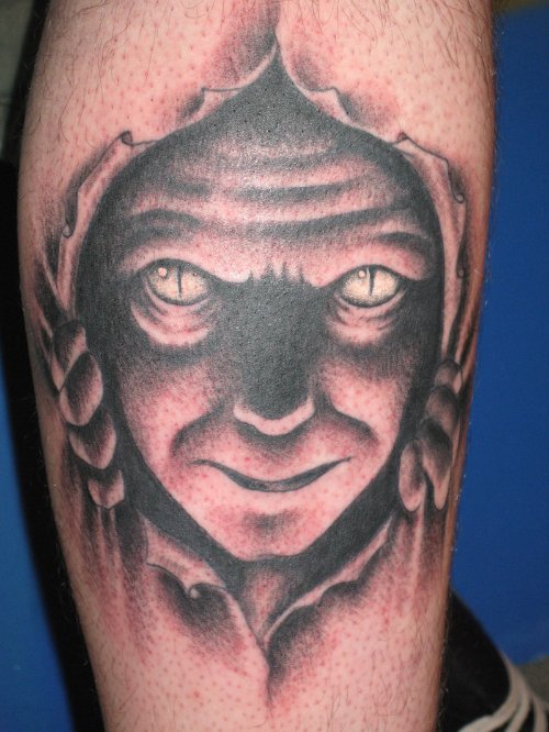 Ripped Skin Devil Face Tattoo On Leg