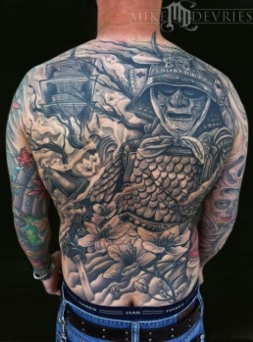 Flowers And Devil Tattoo On Man Back Body