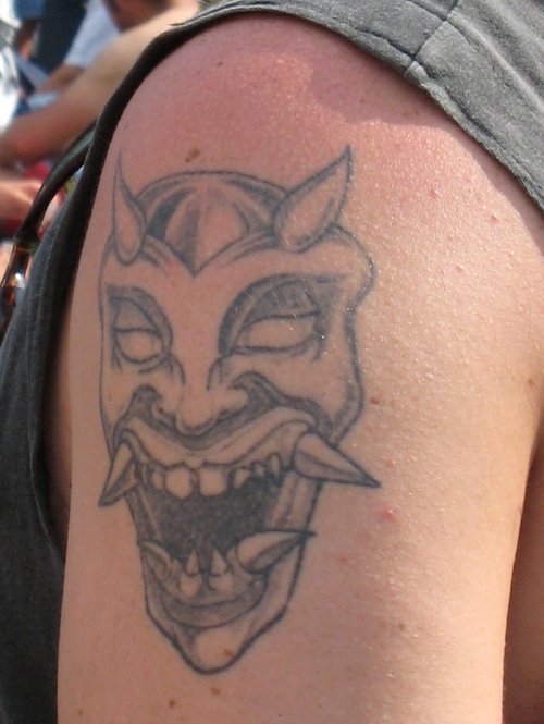 Grey Ink Devil Tattoo On Upper Arm