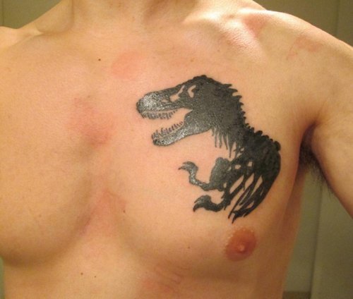 Black Ink Dinosaur Tattoo On Left Chest