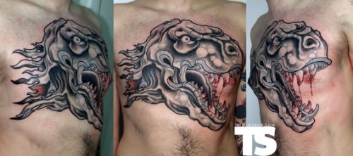 Evil Dinosaur Head Tattoo On Man Chest