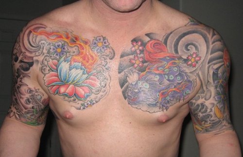 Asian Lotus Flowers And Foo Dog Tattoos On Man Chest