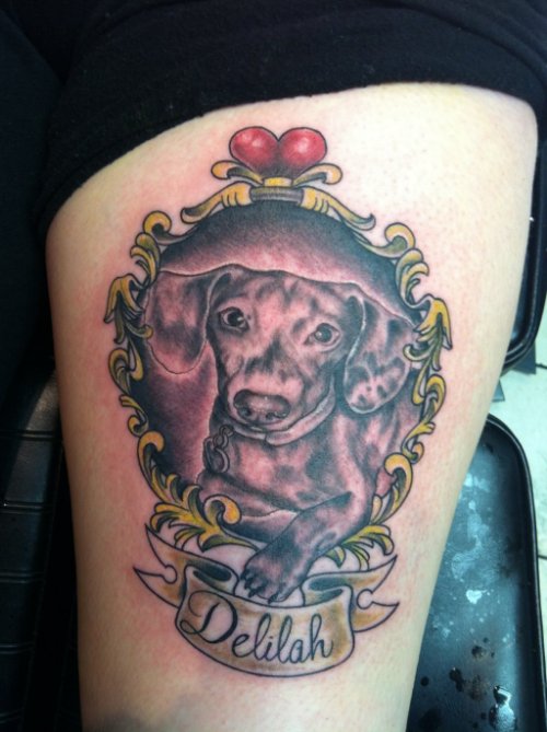 Banner And Dog Tattoo On Thigh