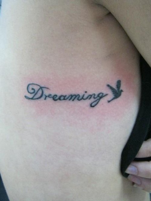 Dreaming and Dove Tattoo On Rib Side