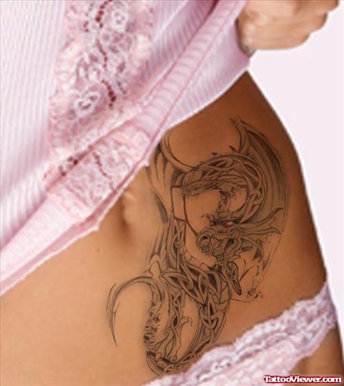 Grey Ink Celtic Dragon Tattoo On Hip