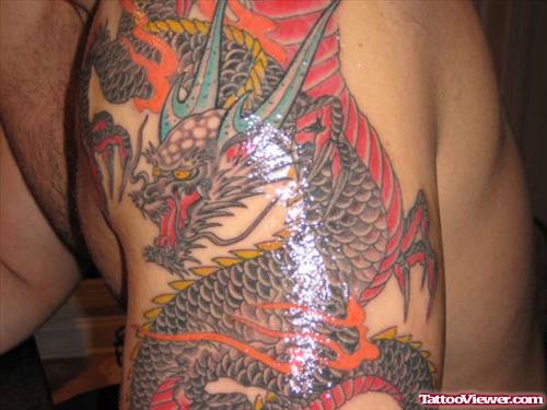 Colorful Dragon Tattoo On Man Left Shoulder