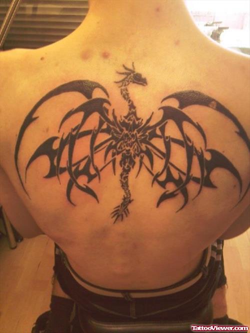 Black Ink Tribal Dragon Tattoo On Girl Upperback
