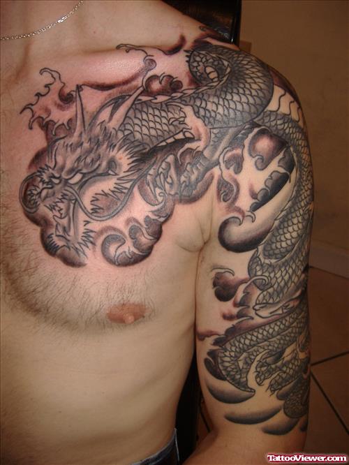 Grey Ink Dragon Tattoo On Chest And Left Sleeve