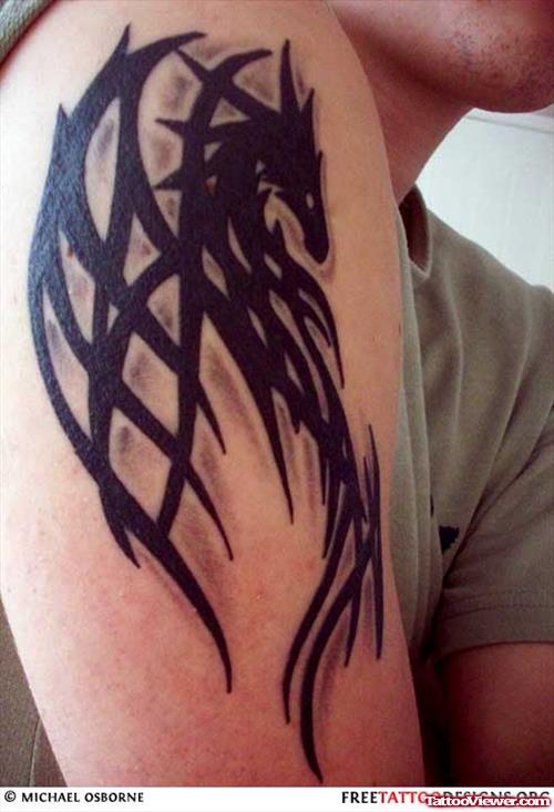 Black Ink Tribal Dragon Tattoo On Right Bicep
