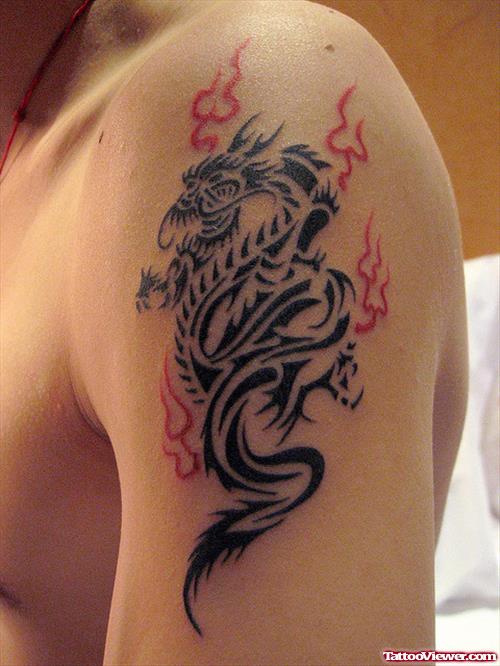 Black And Red Ink Tribal Dragon Tattoo On Left SHoulder