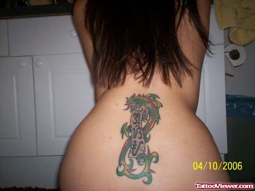 Tribal Green Dragon With Scroll Banner Tattoo On Girl Lowerback