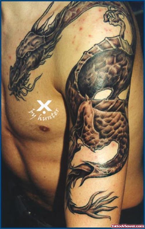 Grey Ink Dragon Tattoo On Chest And Half Sleeve