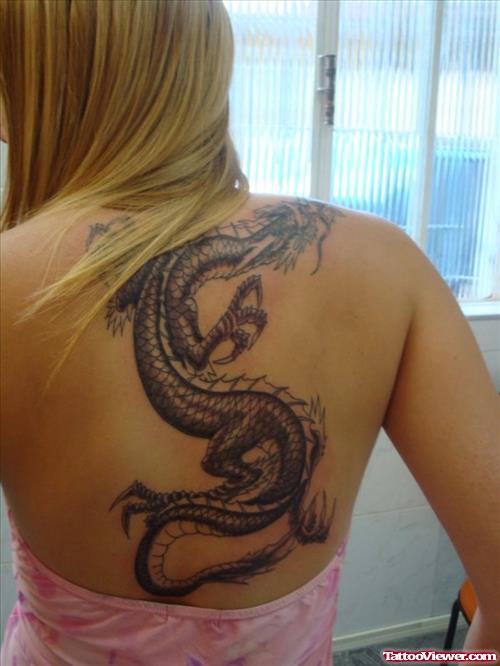 Grey Ink Dragon Tattoo On Girl Upperback