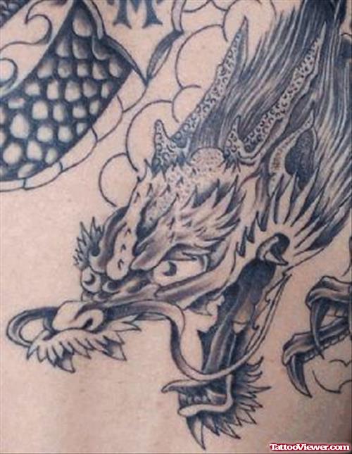 Grey Ink Dragon Head Tattoo