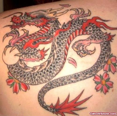 Japanese Flowers And Colored Dragon Tattoo On Back