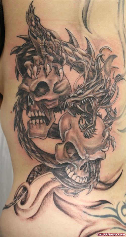 Grey Ink Skull And Dragon Tattoo On Side