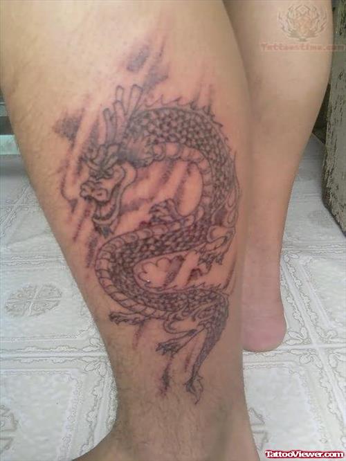 Grey Ink Dragon Tattoo On Left Leg