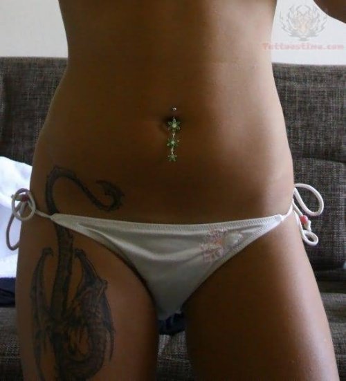 Belly Piercing And Dragon Tattoo On Thigh