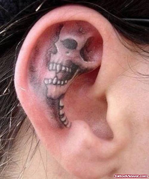 Awful Grey Ink Skull Right Ear Tattoo