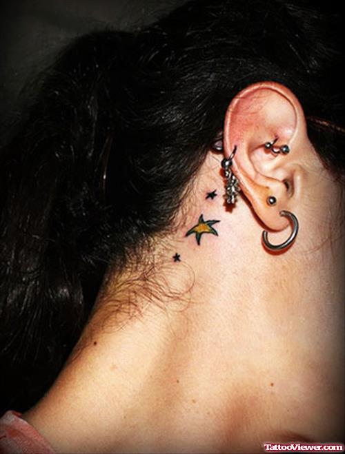 Yellow Star Behind Ear Tattoo