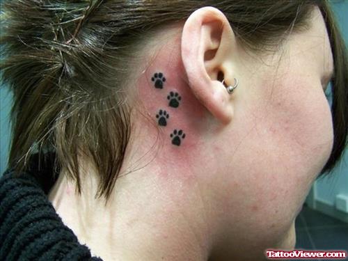 Black Ink Small Paw Prints Back Ear Tattoo