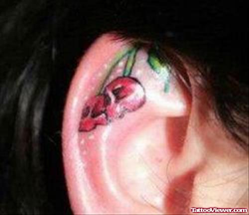 Red Ink Cherry Skulls Ear Tattoo