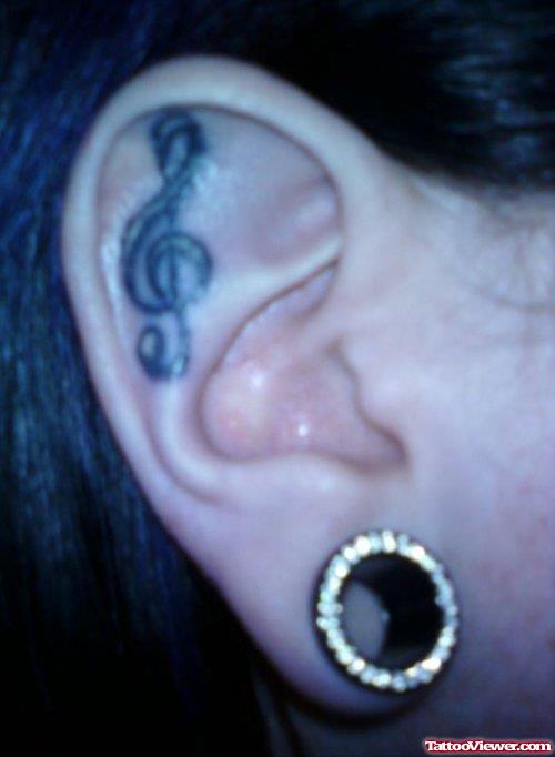 Grey Ink Music Note Ear Tattoo