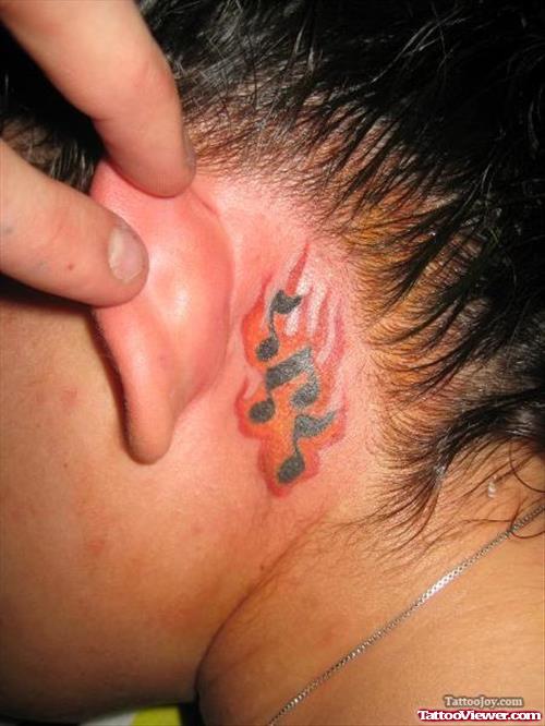 Flaming Music Notes Behind Ear Tattoo
