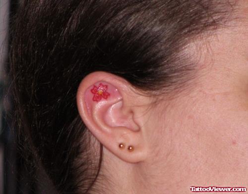 Red Flower Inside Ear Tattoo