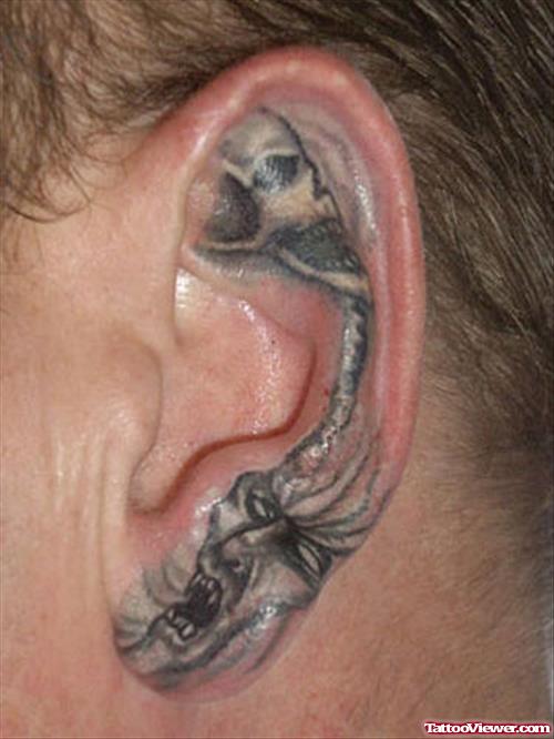 Grey Ink Skulls Left Ear Tattoo