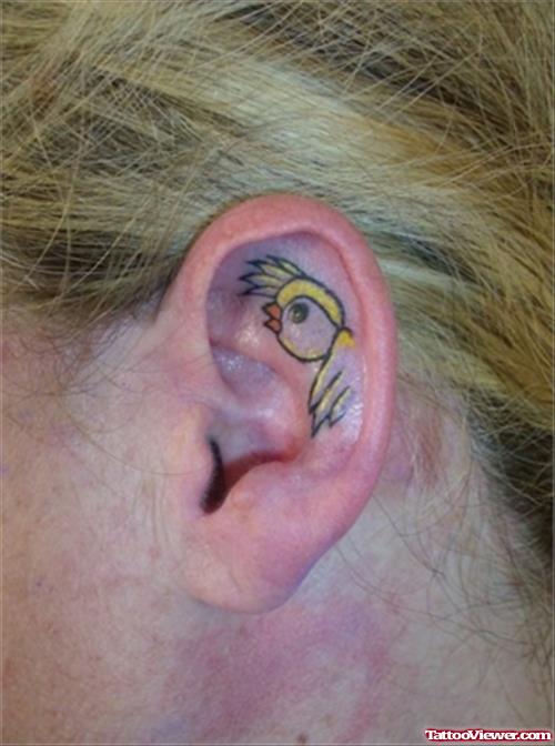 Flying Yellow Bird Left Ear Tattoo