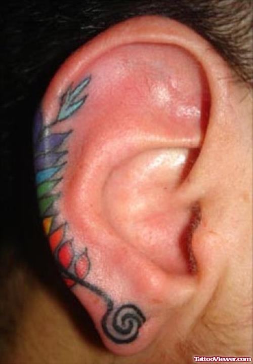 Colored Feather Tattoo On Right Ear