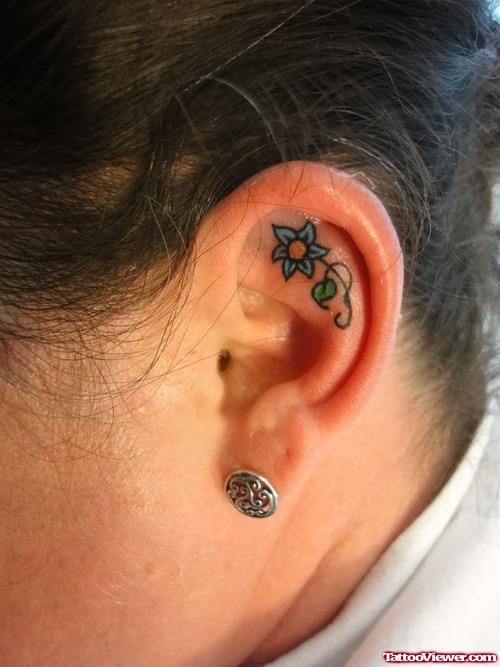Blue Ink Flower Left Ear Tattoo