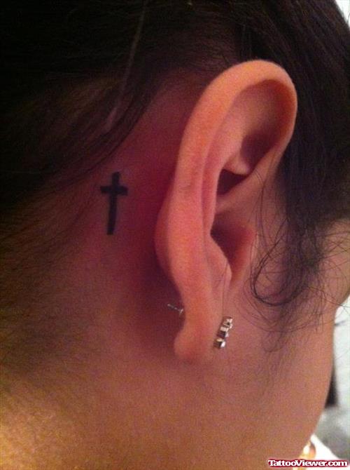 Black Ink Tiny Cross Below Ear Tattoo