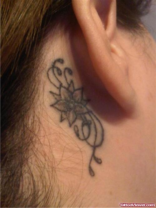 Grey Ink Flower Tattoo Behind Ear